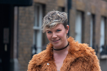 Portrait of a young woman in furry coat