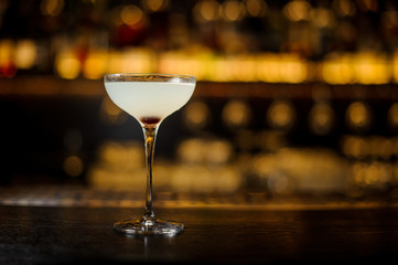 Elegant glass of fresh sweet and sour cocktail on bar counter