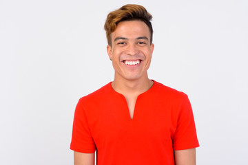 Face of happy young Asian man smiling and looking at camera