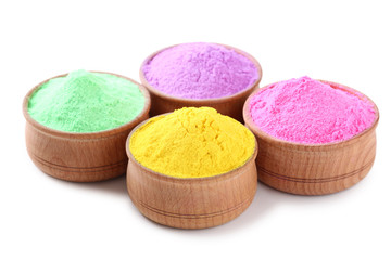 Colorful holi powder in bowls on white background
