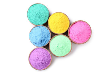 Colorful holi powder in bowls on white background