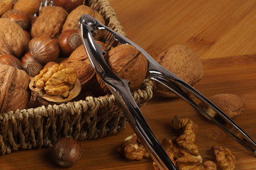 Nutcracker based on the basket. Braided basket filled with nuts: walnuts, brazilian, hazelnuts and...