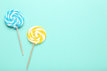 Colorful lollipops on mint background