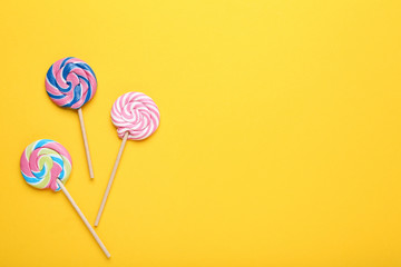 Colorful lollipops on yellow background