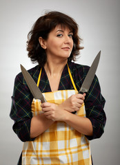 Woman cook holding knives