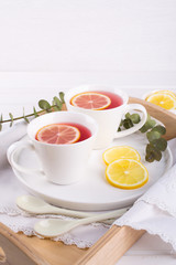 Two cups of red fruit and herbal tea with lemon slice, top view