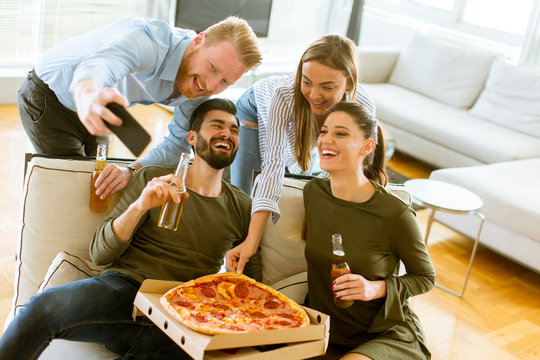 Group of young people having pizza party