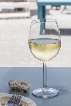 Wine glass with chilled white wine at beach restuarant table at West Coast South Africa