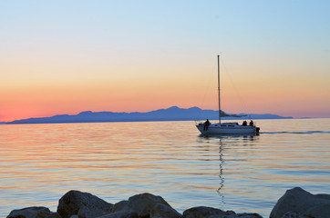 Sailboat on the water in lake at sunset