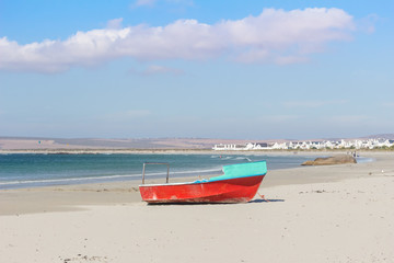 An old fishing boat on the white sand of the beach at Paternoster on a bright summer sunny day - Image