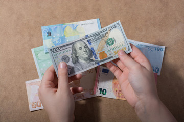 Hand holding American dollar  isolated on wooden background