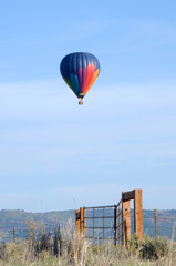 Hot air balloon solo over a field