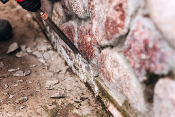 Fototapeta premium Worker use concrete electric drill (breaker). Crushing of concrete or stone.