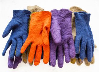 heap from new felted gloves on gray