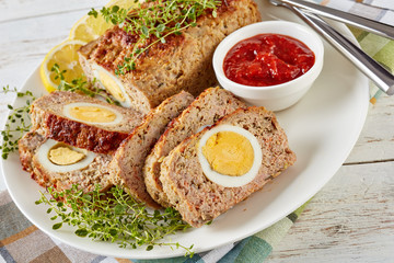 Meatloaf stuffed with hard boiled egg, close-up