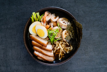 Asian soup with udon, shrimps, egg and roasted pork