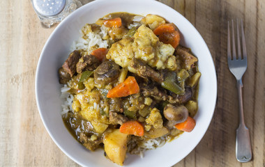 Stew and dumplings - Top view close up photo of rustic stew on wooden table