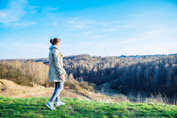 woman looking forward on the top of the hill on sunset. copy space