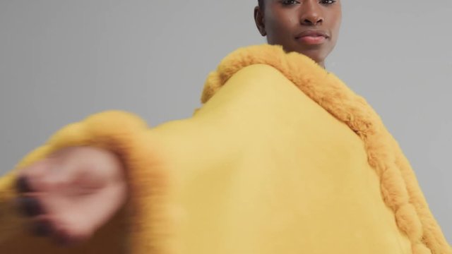 black mixed rase dancing, rolling in studio in yellow outwear