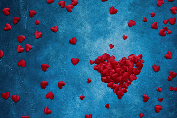 Valentines Day background. Red hearts  on dark blue background. Copy space, top view.