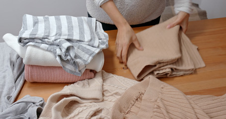 Housewife fold clothes at home