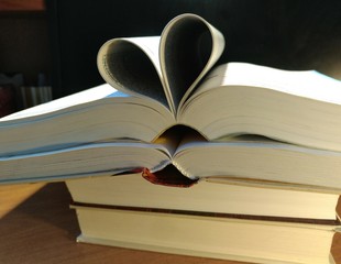 Heart of paper on a black wall