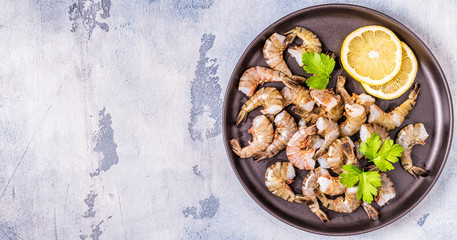 Raw shrimps with parsley and lemon.