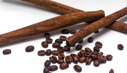 Roasted Coffee Beans and Cinnamon on the white background close-up. Cinnamon with Roasted Coffee Beans on white background  isolated close-up. Coffee,cinnamon,mood,relax,morning.