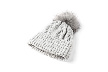 Gray winter knitted hat with boom isolated on white background.