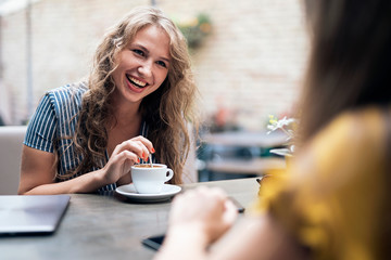 Relaxing women enjoying coffee together