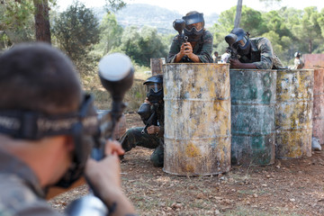 Fototapeta premium Paintball players in shootout outdoors