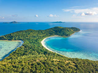 Aerial view of tropical  beach on island Ditaytayan. Beautiful tropical island with white sandy beach, palm trees and green hills. Travel tropical concept. Palawan, Philippines