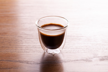 Cup of espresso coffee on wooden background.