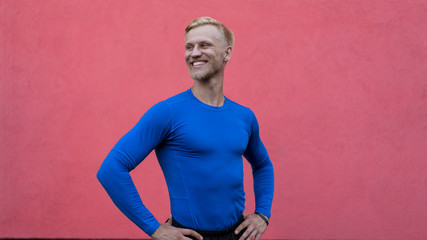 Young attractive man standing on red background © Vasya