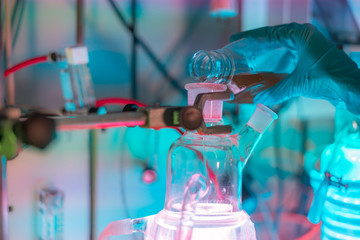 Female scientist working in a biotechnology laboratory with reactors and microalgae cultivation