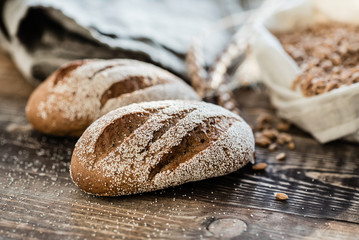 fresh bread with flour on the wooden background