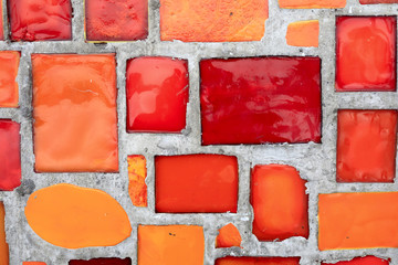 Red mosaic in concrete wall