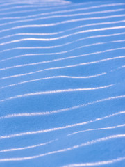 Snow, waves, light and shadow, background. Beautiful winter abstract background.
