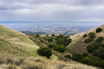 Fototapeta na wymiar Hills and valleys in Alum Rock Park on a rainy day; San Jose, California in the background