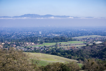 Fototapeta na wymiar Aerial view of Cupertino and San Jose, Silicon valley; south San Francisco bay area; Mount Hamilton summit (and the observatories) in Diablo mountain range in the background; California