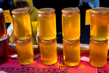 Glass jar of honey set with lid closeup