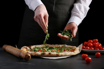 chef make vegetarian pizza with cherry tomatoes and arugula