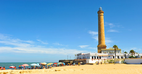 Fototapeta na wymiar The famous beach and lighthouse of Chipiona (Faro de Chipiona) in the coast of Cadiz. The highest in Spain.
