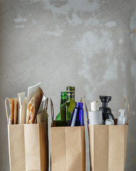 Three paper bags with sorted household waste