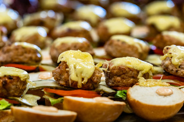 Closeup View of Sliced Bread Spread on the Table with Ingredients on them for Small Burgers - Kitchen Set