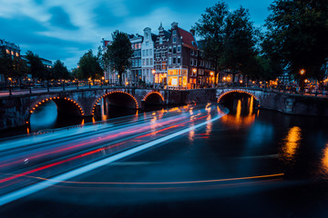 Famous Amsterdam Canal and magic light trails of a Vessel