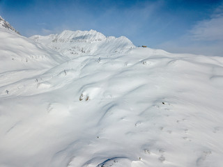 Aerial view of snow covered mountains in Swiss alps. Beautiful panorama of wild and tranquil...