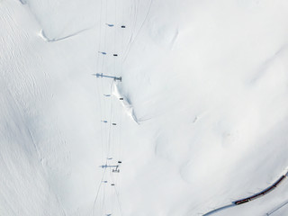 Aerial view of ski chairlift on snow covered mountain in Switzerland