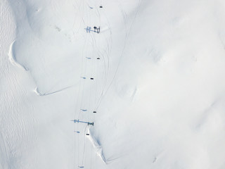 Aerial view of ski chairlift on snow covered mountain in Switzerland