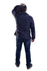 Fototapeta premium thinking man with hat in hand and jacket stands with his back to the viewer, isolated on white background